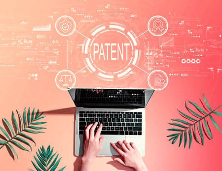 Patent concept with person using a laptopの写真素材