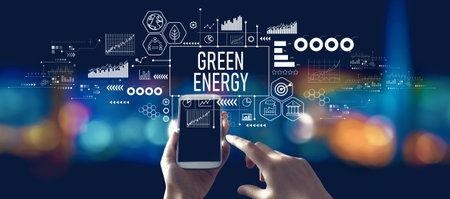 Green Energy concept with person using a smartphone at nightの写真素材
