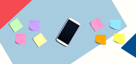 Smartphone with many colurful sticky notes from aboveの写真素材