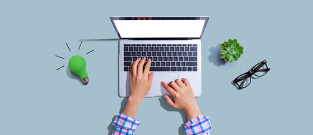 Green light bulb with a laptop computerの写真素材