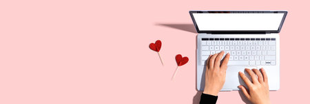 Laptop computer with heart cushionsの写真素材
