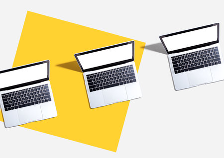 Three laptop computers with shadowの写真素材