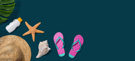 Summer concept with a straw hat, sunblock, starfish, and beach sandalsの写真素材