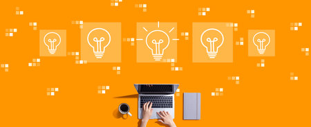 Idea light bulb theme with person working with laptopの写真素材