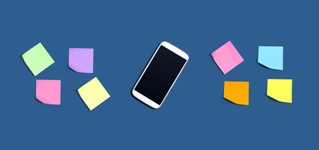 Smartphone with many colurful sticky notes from aboveの写真素材