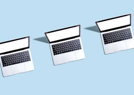 Three laptop computers with shadowの写真素材