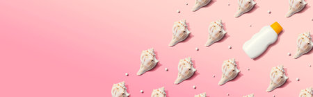 Sunblock bottle with seashells with shadowの写真素材