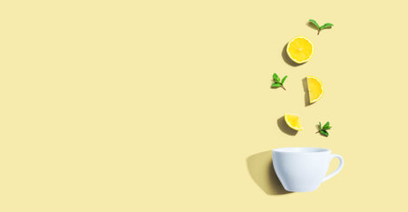 Fresh yellow lemons with tea cup overhead viewの写真素材