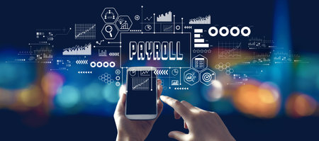 Payroll theme with person using a smartphone at nightの写真素材