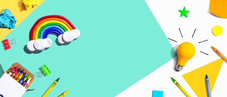 Idea light bulb with a rainbow and school supplies - flat layの写真素材