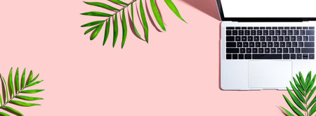 Laptop computer with tropical leavesの写真素材