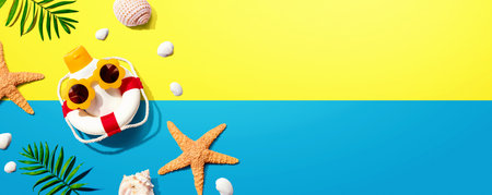 Sunblock bottle wearing sunglasses with starfish and seashellsの写真素材
