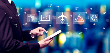 Flight ticket booking concept with businessman using a tablet computerの写真素材