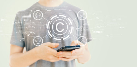 Copyright concept with man using a smartphoneの写真素材