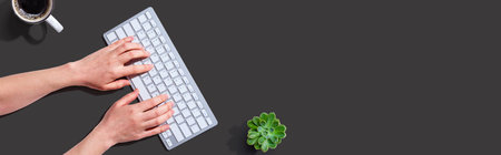 Woman using a computer keyboardの写真素材
