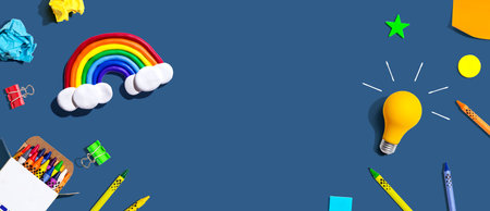 Idea light bulb with a rainbow and school supplies - flat layの写真素材