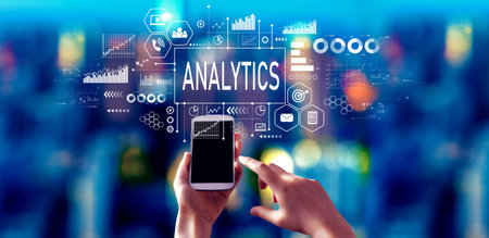 Analytics theme with person using a smartphone at nightの写真素材