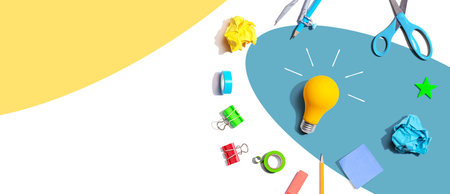Idea light bulb with school supplies - flat layの写真素材