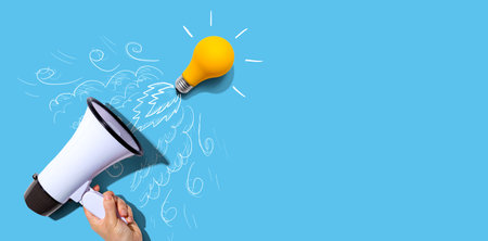 Attention and announcement concept with an idea light bulb flying to the sky like a rocketの写真素材
