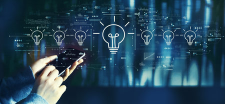 Idea light bulb theme with person using smartphoneの写真素材