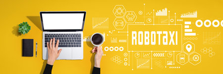 Robotaxi theme with person using laptop computerの写真素材