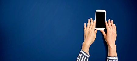Person using a white smartphoneの写真素材