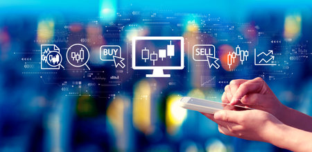 Stock trading theme with person using a smartphone at nightの写真素材