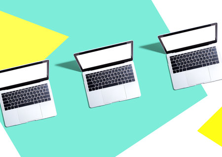 Three laptop computers with shadowの写真素材