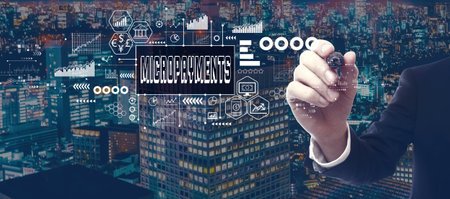Micropayments theme with businessman in city at nightの写真素材