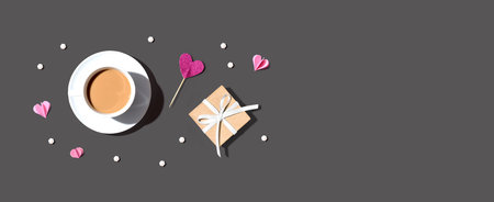 A cup of coffee with a gift box and heartsの写真素材