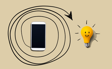 Creativity, inspiration, idea concept with light bulb and smartphoneの写真素材