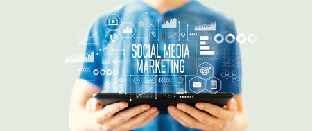 Social media marketing theme with man using a tabletの写真素材