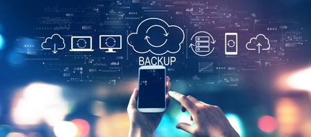 Backup concept with a smartphone in city lights at nightの写真素材
