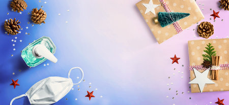 Christmas gift boxes with a mask and a sanitizer bottleの写真素材