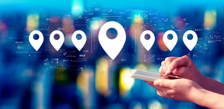 Map pin concept with person using a smartphone at nightの写真素材