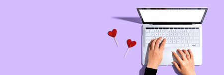 Laptop computer with heart cushionsの写真素材