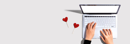 Laptop computer with heart cushionsの写真素材