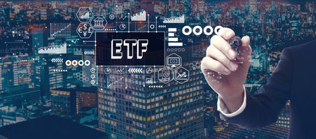 ETF theme with businessman in city at nightの写真素材