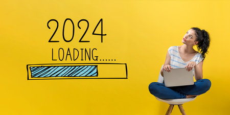 Loading new year 2024 with woman using a laptopの写真素材