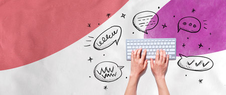 Speech bubbles and a computer keyboardの写真素材