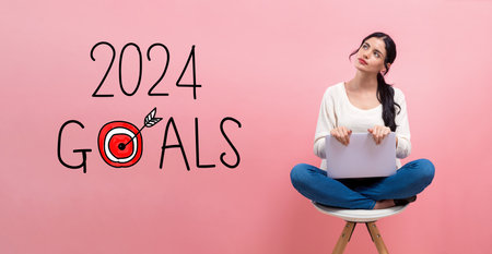 2024 goals concept with woman using a laptopの写真素材