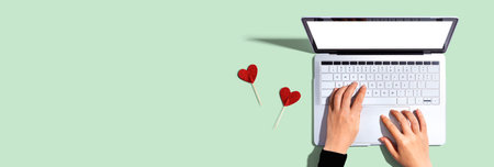 Laptop computer with heart cushionsの写真素材