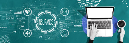 Insurance concept with person using a laptopの写真素材