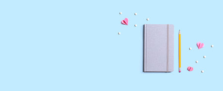 Gray notebook with paper heartsの写真素材