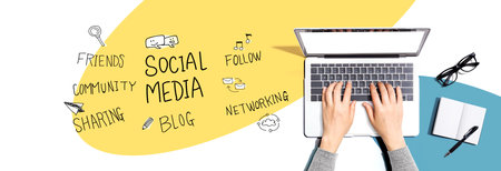 Social media theme with person using a laptopの写真素材