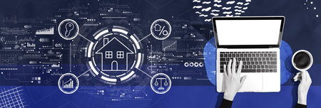 Real estate theme with person using a laptopの写真素材