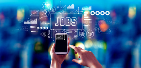 Job theme with person using a smartphone at nightの写真素材