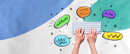 Speech bubbles and a computer keyboardの写真素材