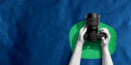 Person holding a SLR cameraの写真素材