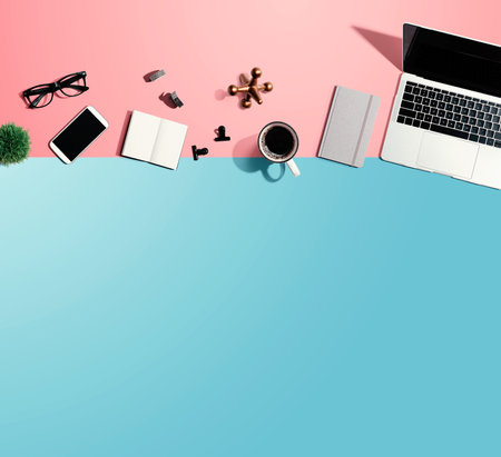 Laptop computer with office suppliesの写真素材